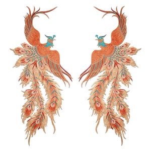 May include: Two embroidered phoenixes with orange and gold feathers and turquoise accents. The phoenixes are facing opposite directions and have their wings spread out.