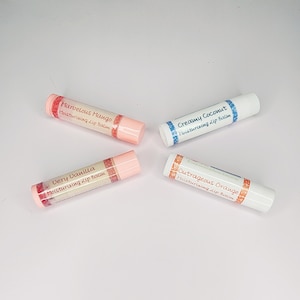May include: Four different flavored lip balms in tubes. The tubes are white with colorful labels. The flavors are: Marvelous Mango, Very Vanilla, Creamy Coconut, and Outrageous Orange.