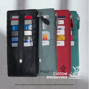 May include: A collection of slim, vertical wallets in black, teal, red, and turquoise. Each wallet features multiple card slots and a zipper closure. The black wallet has a wrist strap and the initials "AJ". The red wallet has a Japanese character.