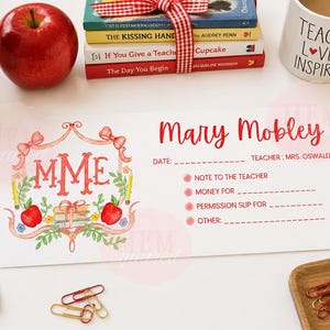 May include: A rectangular white note card featuring the name Mary Mobley in red script, with fields for date, teacher, and checkboxes for note, money, permission slip, and other. The design includes a red monogram MME, apples, and books.