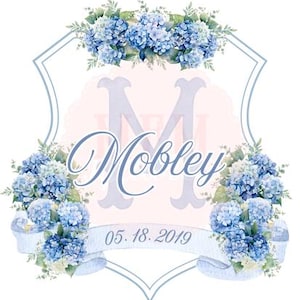 May include: A watercolor design featuring blue hydrangeas, a light blue shield, and the name "Mobley" in cursive. The date "05.18.2019" is on a banner below the name. The design has a soft, romantic feel.