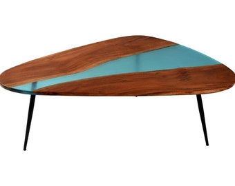 May include: A distinctive coffee table featuring a wooden top with a turquoise resin river design. The table has a triangular shape and is supported by three black metal legs. The wood has a natural grain, and the table is suitable for a living room. The table is approximately 120 cm long.
