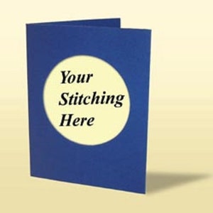 May include: A folded blue card with a cream-coloured circle in the centre. The text "Your Stitching Here" is printed in black within the circle. The card is on a light yellow background.