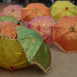 May include: A collection of colorful umbrellas with intricate patterns. The umbrellas are made of fabric and have a variety of colors, including red, orange, yellow, green, and blue. The umbrellas are arranged in a semi-circle, with the handles pointing towards the center.