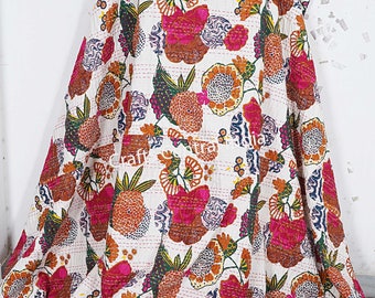 May include: A white kantha quilt with a floral pattern in shades of pink, orange, and green. The quilt is made of cotton and is hand-stitched.