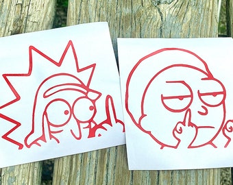 Puede incluir: Dos pegatinas de vinilo rojo con personajes de dibujos animados haciendo un gesto obsceno. Una pegatina muestra un personaje con pelo puntiagudo y ojos grandes, la otra un personaje con el ceño fruncido.
