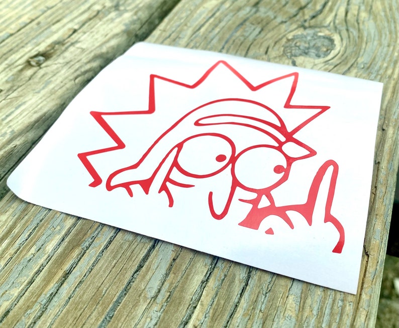 Puede incluir: Una pegatina de personaje de dibujos animados rojo con una cabeza puntiaguda y rasgos faciales exagerados, mostrando el dedo medio. La pegatina est&aacute; sobre un fondo blanco.