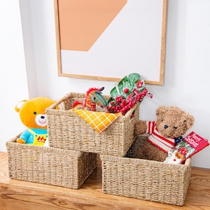 May include: Three woven storage baskets with a brown and beige pattern. The baskets are filled with stuffed toys, including a teddy bear, a rocking horse, and a red and white striped teddy bear.