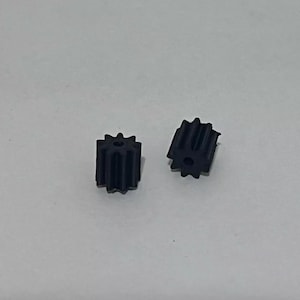 May include: Two small black plastic gears with teeth.