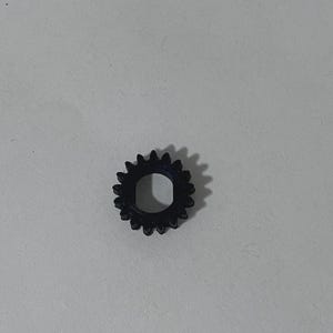 May include: A small, black, circular gear featuring a series of evenly spaced teeth around its outer edge and a central hole with a flat side, designed for mechanical rotation and power transmission within a larger assembly or device.