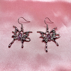 Pretty cute funky quirky alt emo goth grunge aesthetic, silver butterfly with pink gemstone earrings