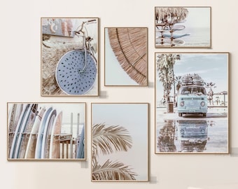 May include: Set of 6 framed prints with a beach theme. The prints feature a vintage bicycle, a palm tree, a surfboard, a van, and a thatched roof. The prints are in a light blue and white color scheme.