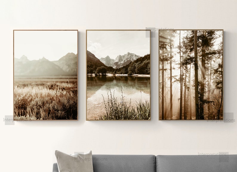 May include: Set of three sepia toned landscape photographs. The first image shows a mountain range with a field of tall grass in the foreground. The second image shows a lake with mountains in the background. The third image shows a forest with sunbeams shining through the trees.