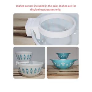 May include: White plastic bowl rack with a white plastic ring for stacking bowls. The rack has the text "SL Stands Chip & Dip" printed on it. The rack is shown with two blue and white bowls with a geometric pattern.