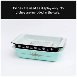 May include: Two rectangular, vintage-style baking dishes. The bottom dish is a light turquoise with a gold starburst design. The top dish is black with white snowflake accents. Text on the image reads: Dishes are used as display only. No dishes are included in the sale.