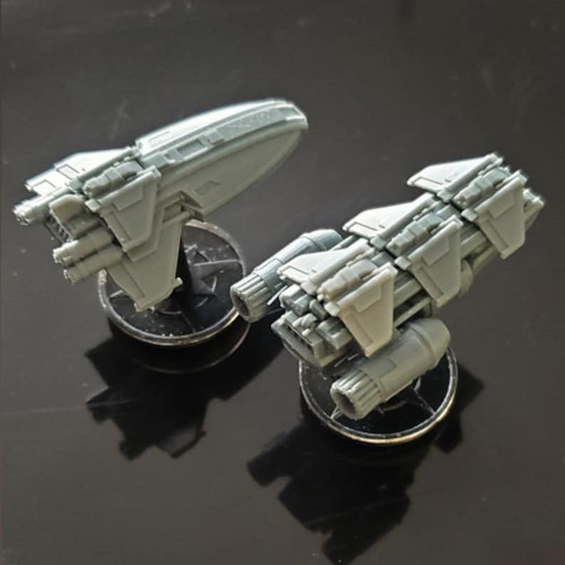 K&ouml;nnte beinhalten: Zwei graue Miniatur-Raumschiffe auf schwarzen Sockeln. Die Raumschiffe haben detaillierte Designs und sind aus Kunststoff.