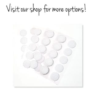 May include: A close-up of a sheet of white adhesive dots. The dots are round and have a textured surface.