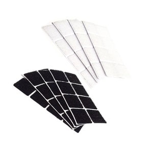 May include: A set of black and white adhesive squares for attaching items to surfaces. The squares are arranged in a fan shape.