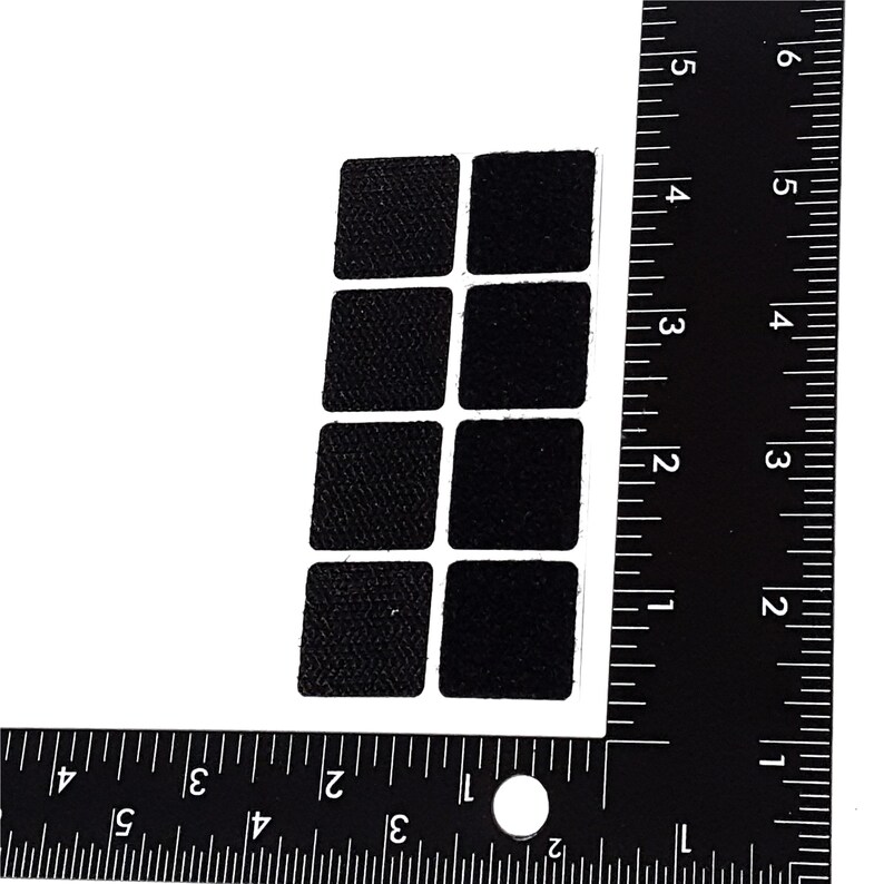 May include: A sheet of nine black, square, adhesive hook and loop fasteners. The fasteners are approximately 1 inch by 1 inch.