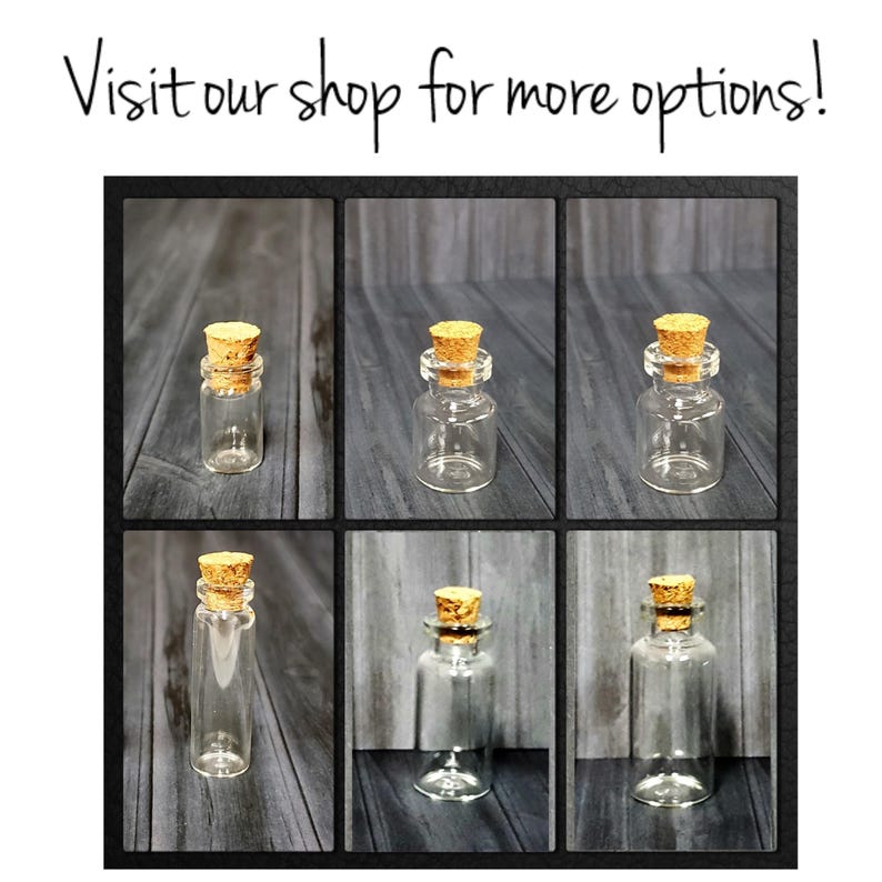 May include: Six clear glass bottles with cork stoppers. The bottles are arranged in two rows of three. The bottles are all the same size and shape.