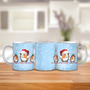 May include: Three white ceramic mugs with a blue and white snowflake pattern. The mugs have a Christmas theme with images of guinea pigs wearing Santa hats and the text "Merry Christmas Hoom" and "We wish you a Merry Christmas".