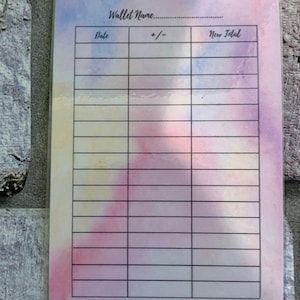 May include: A cash tracker card with a watercolor background in shades of pink, blue, and yellow. The card features the text "CASH TRACKER" at the top, with spaces for "Wallet Name" and a table to track expenses.