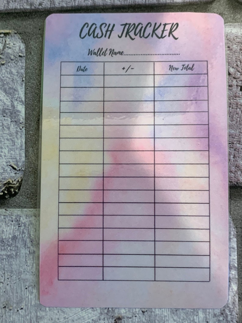 May include: A cash tracker card with a watercolor background in shades of pink, blue, and yellow. The card features the text "CASH TRACKER" at the top, with spaces for "Wallet Name" and a table to track expenses.