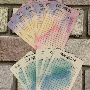May include: A collection of cash tracker cards with watercolor backgrounds in shades of blue, pink, and yellow. Each card is labeled "CASH TRACKER" with spaces for "Wallet Name," "Date," and "+/-," and "New Total."