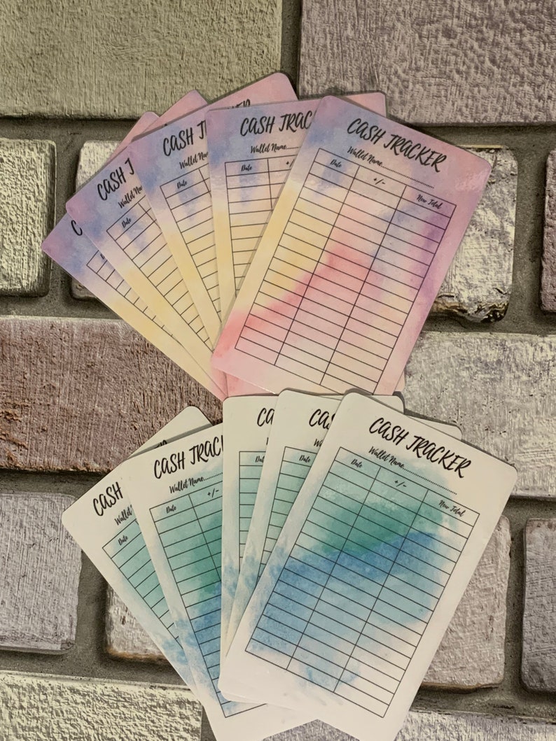 May include: A collection of cash tracker cards with watercolor backgrounds in shades of blue, pink, and yellow. Each card is labeled "CASH TRACKER" with spaces for "Wallet Name," "Date," and "+/-," and "New Total."