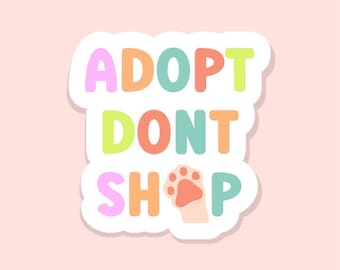May include: A sticker with the text "Adopt Don't Shop" in rainbow colors with a paw print in the middle of the word "Shop".