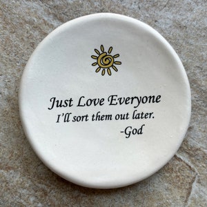 May include: White ceramic dish with a yellow sun design and the text "Just Love Everyone I'll sort them out later. -God"