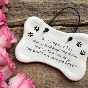 Rescuing one dog may not change the world but for that one dog the world has changed forever. Handmade ceramic hanging dog bone plaque by August Ceramics Gifts