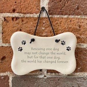 Rescuing one dog may not change the world but for that one dog the world has changed forever. Handmade ceramic hanging dog bone plaque by August Ceramics Gifts