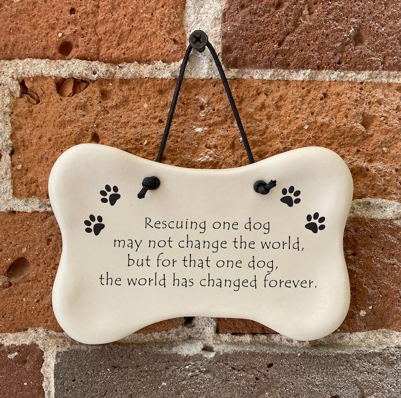 Rescuing one dog may not change the world but for that one dog the world has changed forever. Handmade ceramic hanging dog bone plaque by August Ceramics Gifts