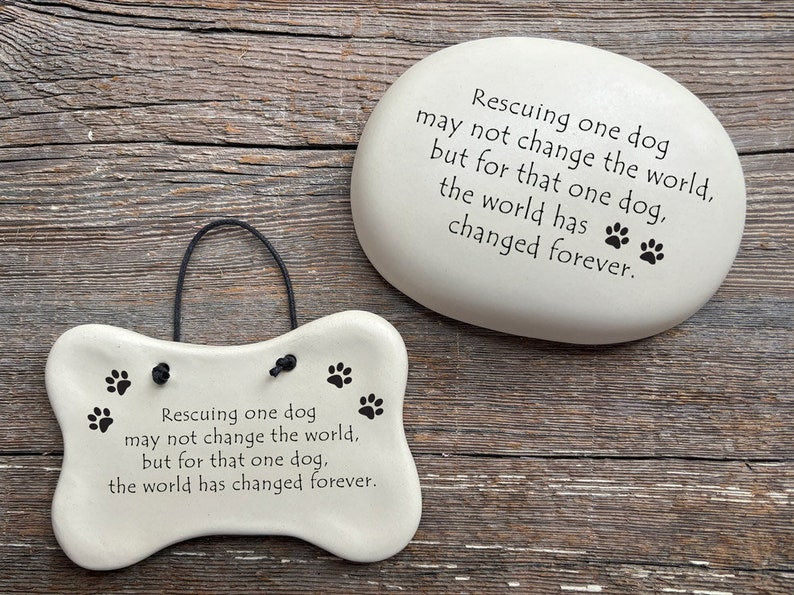 Rescuing one dog may not change the world but for that one dog the world has changed forever. Handmade ceramic garden stone and hanging dog bone plaque by August Ceramics Gifts