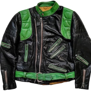May include: A black leather jacket with green leather panels and a zipper closure. The jacket has multiple pockets and a belt.