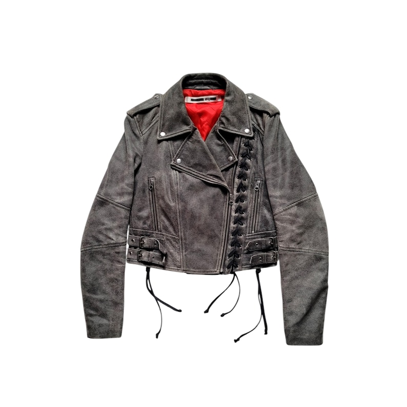 May include: A gray leather motorcycle jacket with black lace-up detailing and a red lining. The jacket has a zipper closure and multiple pockets.