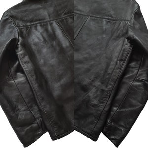 May include: A black leather jacket with a zipper closure and long sleeves. The jacket has a classic design and is made of high-quality leather.