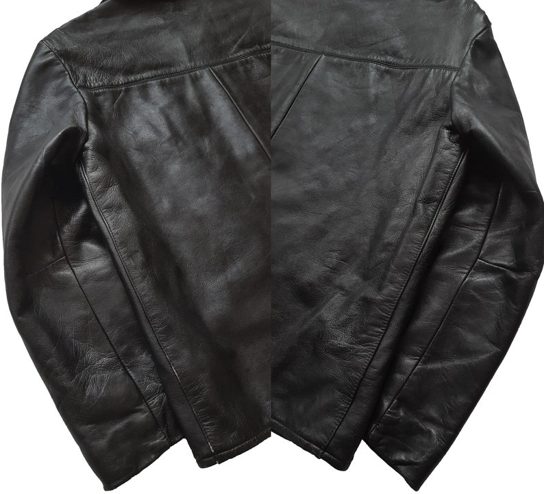 May include: A black leather jacket with a zipper closure and long sleeves. The jacket has a classic design and is made of high-quality leather.