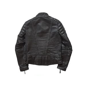 May include: A black leather jacket with quilted detailing on the shoulders and sleeves. The jacket has a zipper closure and a stand-up collar.