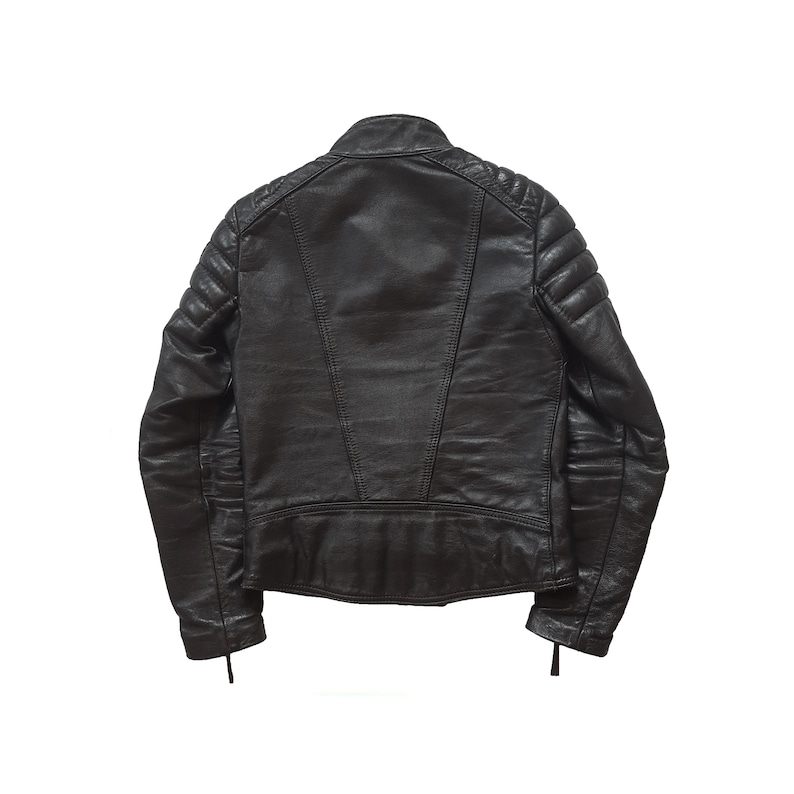 May include: A black leather jacket with quilted detailing on the shoulders and sleeves. The jacket has a zipper closure and a stand-up collar.