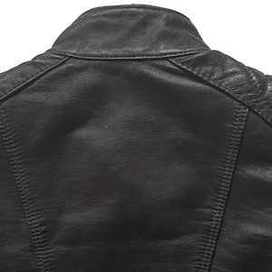 May include: Black leather jacket with quilted detailing on the shoulders and sleeves.
