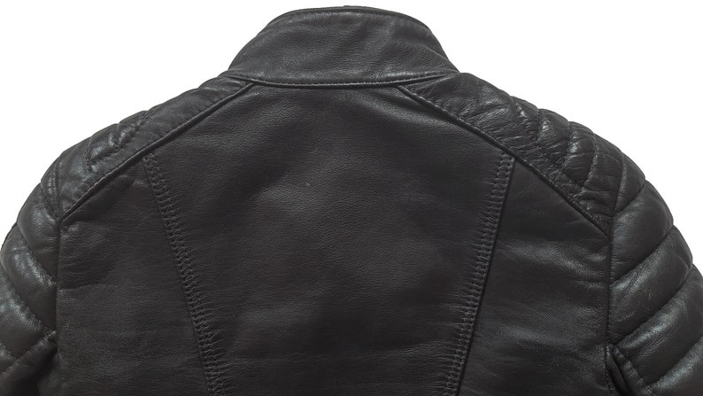 May include: Black leather jacket with quilted detailing on the shoulders and sleeves.