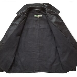 May include: Black leather jacket with a fleece lining. The jacket has a collar and a button closure.