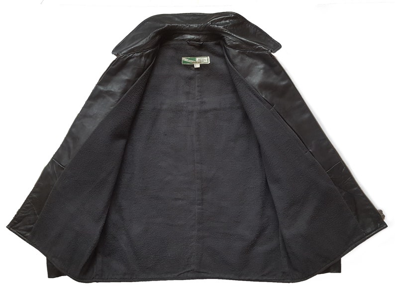 May include: Black leather jacket with a fleece lining. The jacket has a collar and a button closure.
