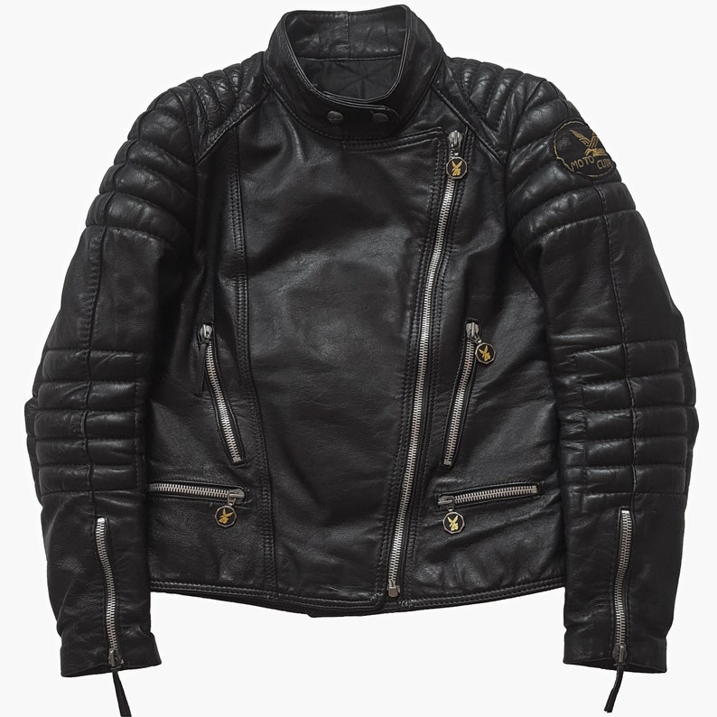 May include: Black leather motorcycle jacket with quilted detailing and zipper accents. The jacket has a zipper closure and a patch on the right sleeve that says "Moto Club".
