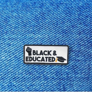 May include: Black and white patch with the text "Black & Educated" and a raised fist and graduation cap.