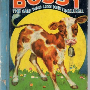 May include: A vintage children's book cover featuring a cartoon calf with brown and white spots. The calf is wearing a bell around its neck and is standing in a field of green grass with yellow flowers. The title of the book is "Bossy: The Calf Who Lost Her Tinkle Bell".
