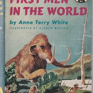 May include: Vintage book cover titled "The First Men in the World" by Anne Terry White, illustrated by Aldren Watson. The cover art features a large woolly mammoth, cavemen, and the text in pink and white.