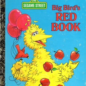 May include: A vintage children's book cover featuring Big Bird from Sesame Street. Big Bird is yellow with an open beak, surrounded by red apples and balloons. The title "Big Bird's RED BOOK" is in large red letters against a blue background.
